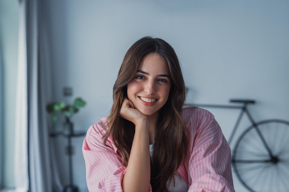 Positive beautiful young latin woman in casual shirt looking at camera, smiling. Confident pretty 30s freelance businesswoman corporate head shot female business portrait Positive beautiful young latin woman in casual shirt looking at camera, smiling. Confident pretty 30s freelance businesswoman corporate head shot female business portrait