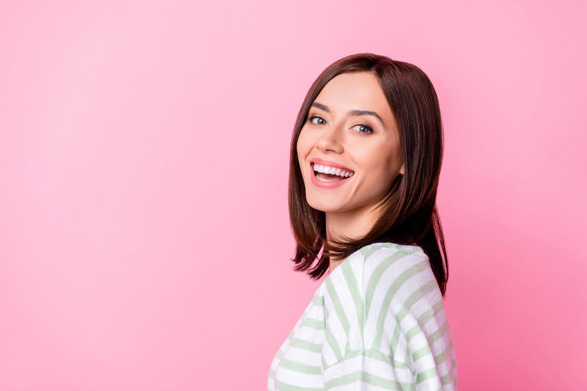 Photo of nice lovely pretty gorgeous girl with bob hairstyle wear striped t-shirt dentistry clinic ad isolated on pink color background Photo of nice lovely pretty gorgeous girl with bob hairstyle wear striped t-shirt dentistry clinic ad isolated on pink color background.