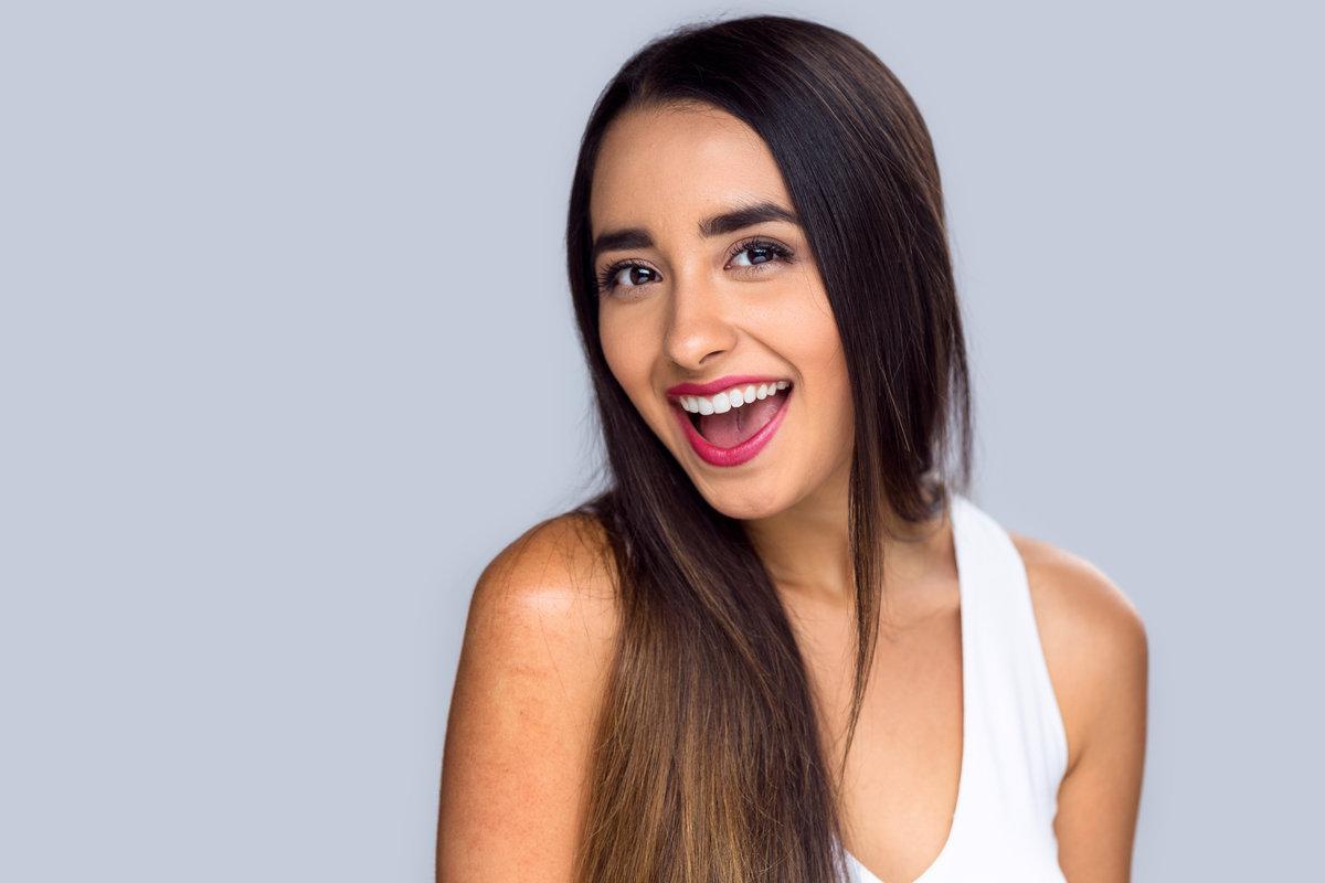Beautiful hispanic girl proud and confident about her perfect white teeth smile Beautiful hispanic girl proud and confident about her perfect white teeth smile