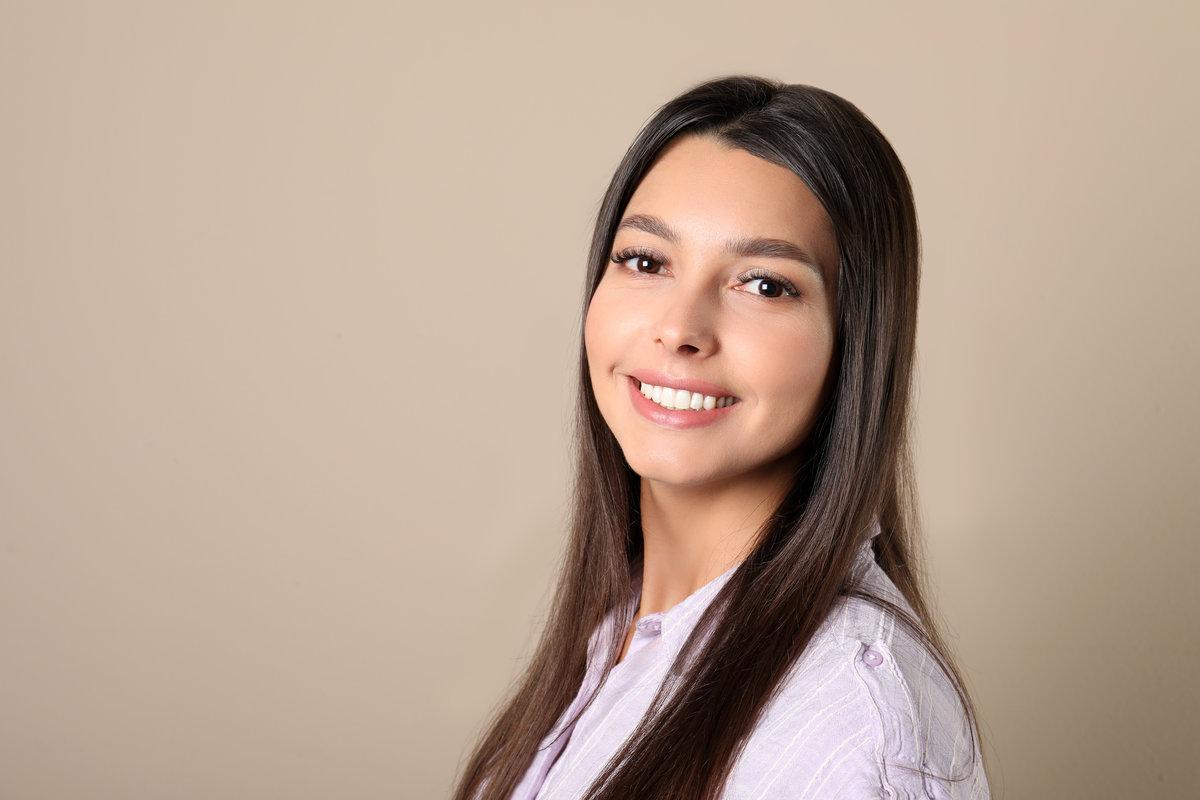 Young woman with healthy teeth on color background. Space for text Young woman with healthy teeth on color background. Space for text